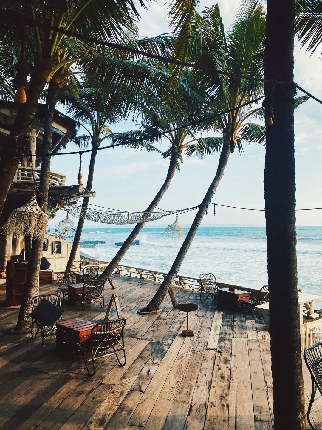 Beachfront café deck among palm trees, Bali